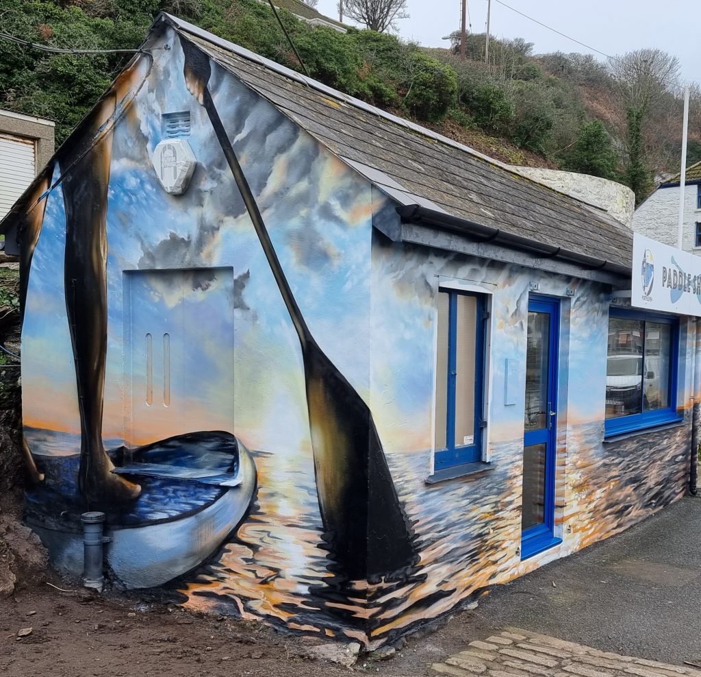 Experienced professional mural artist working on a large-scale mural commission