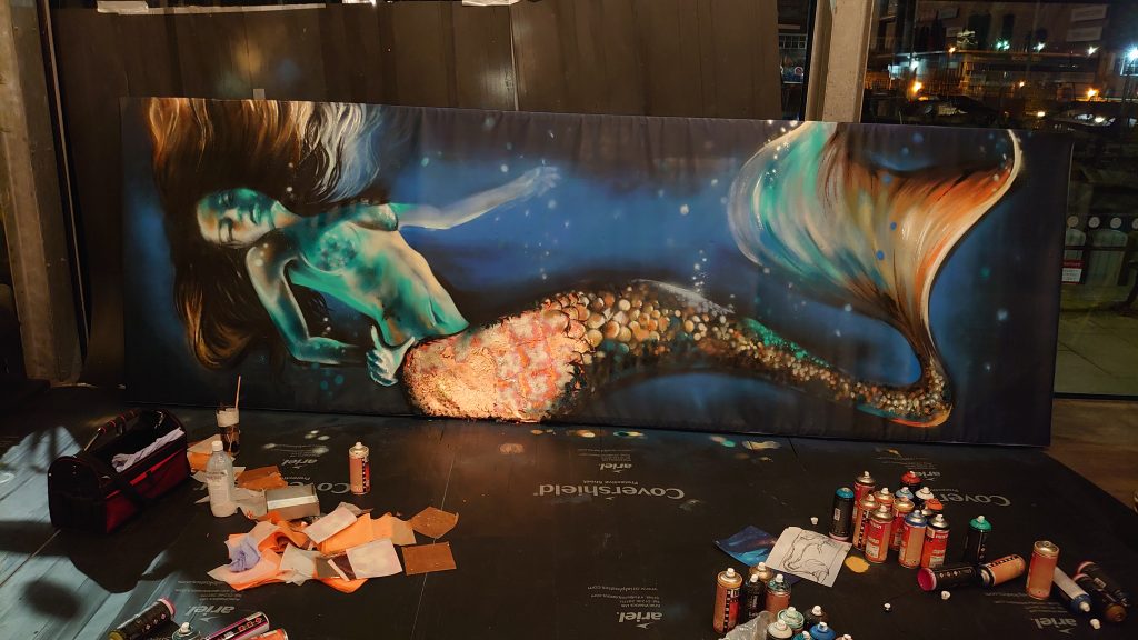 restaurant mural artist devon painted this mermaid canvas with metal leaf